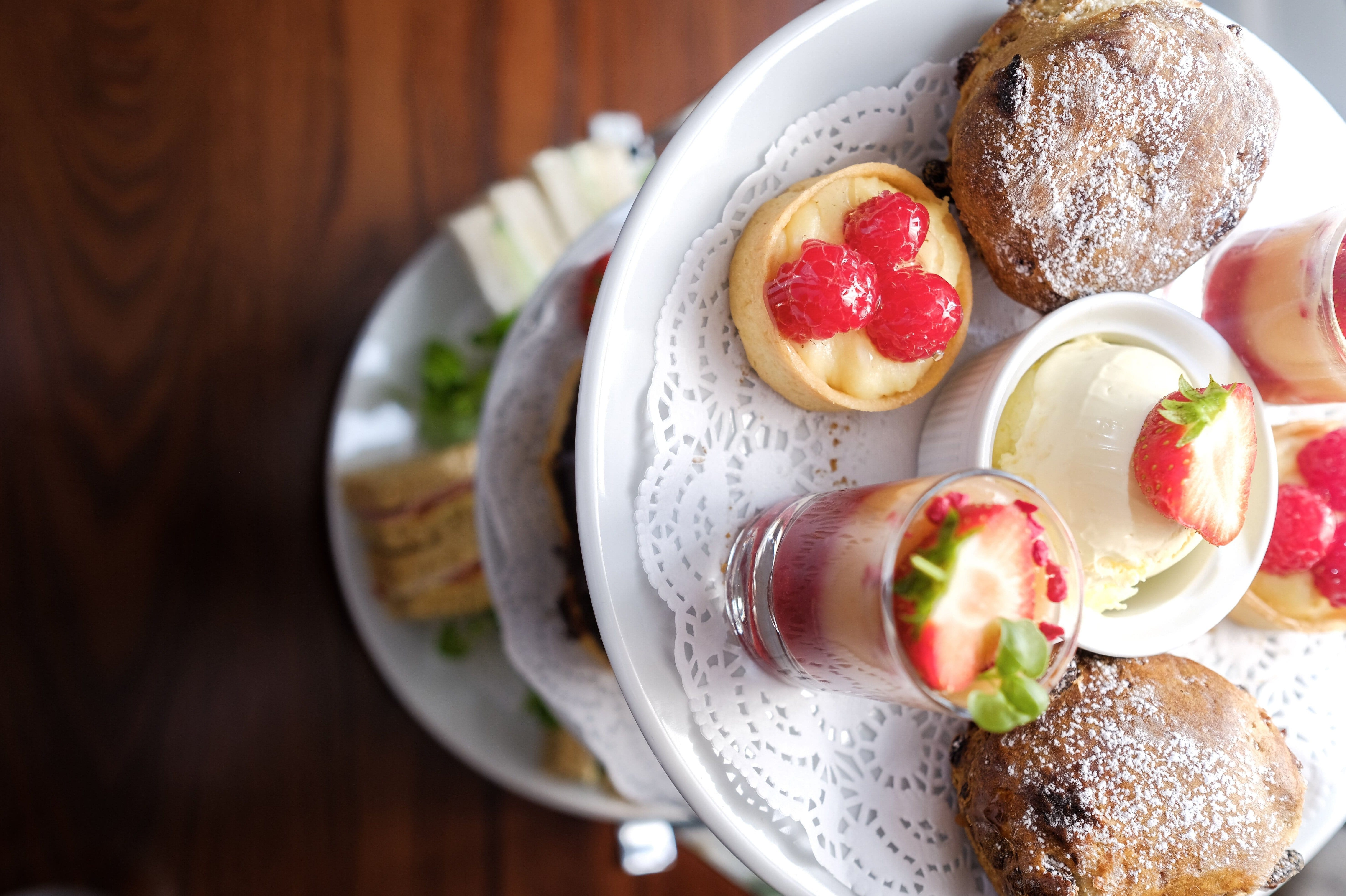 A tiered plate of assorted pastries and desserts for afternoon tea.