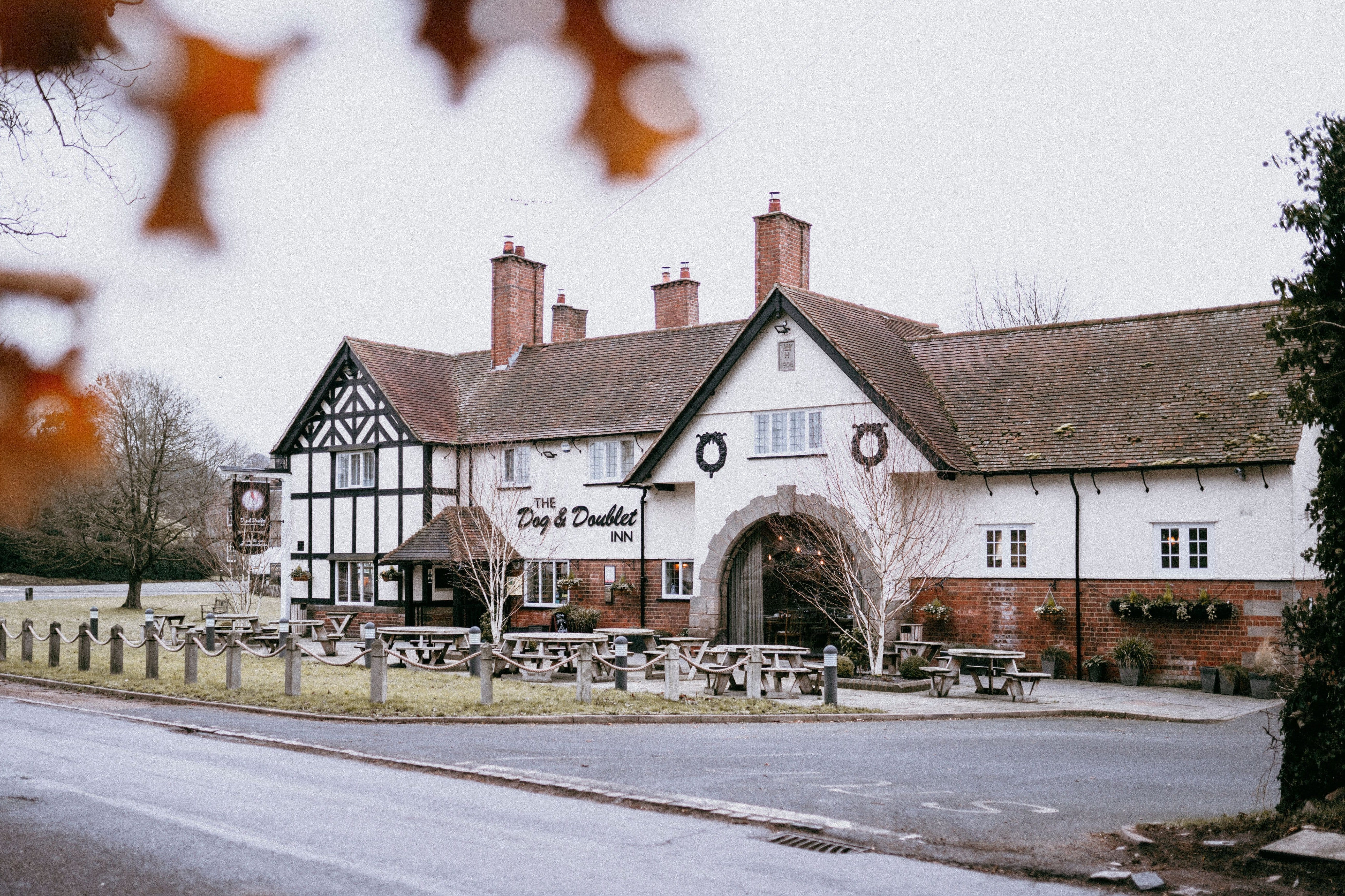 A traditional inn with outdoor seating and a welcoming facade.