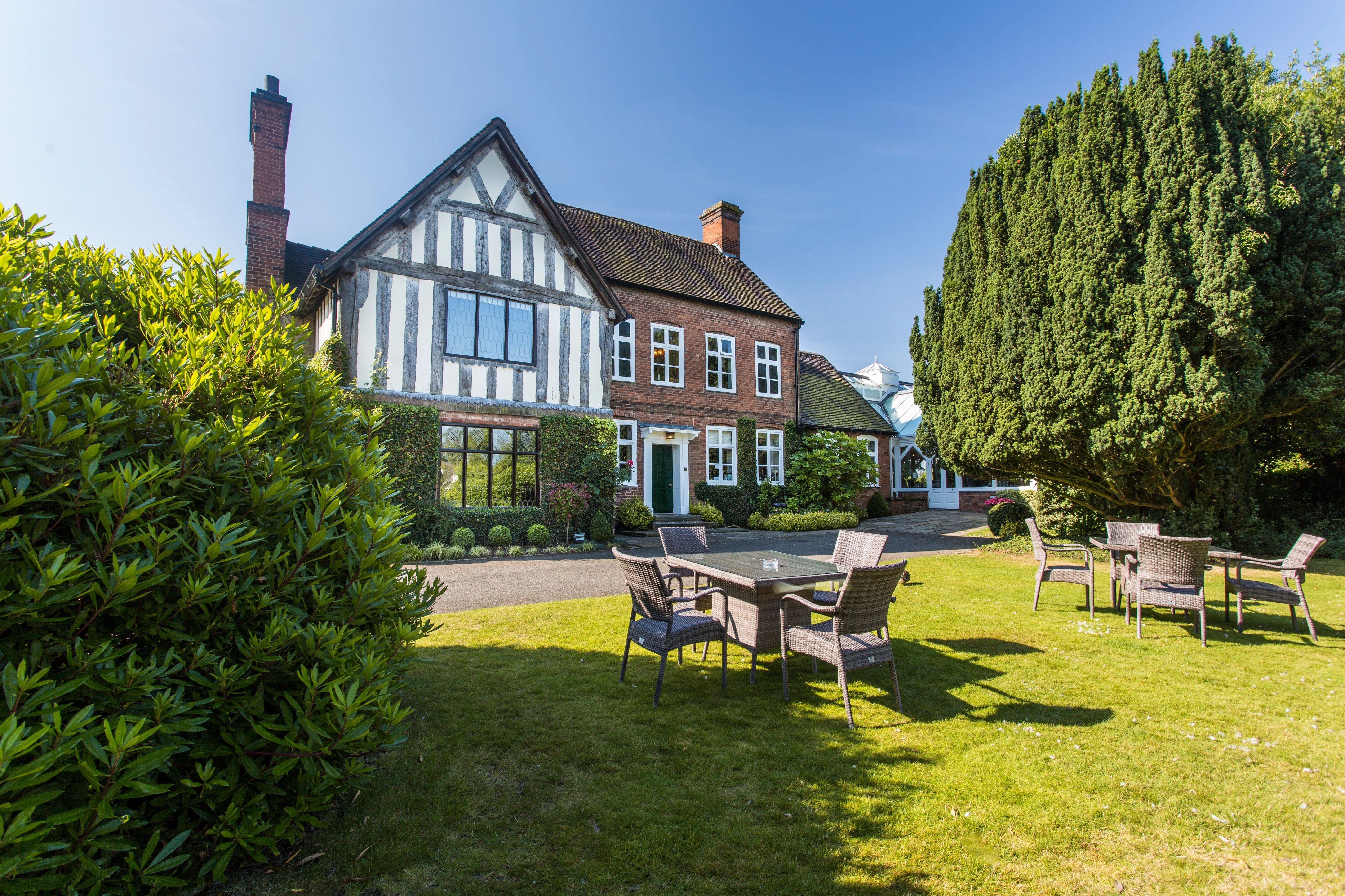 A picturesque cottage with a garden and outdoor seating area.