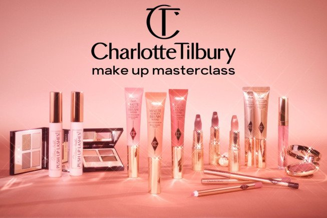 Collection of Charlotte Tilbury makeup products on a pink background